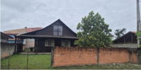 Terreno com casa de madeira em Itapoá, 100m²