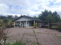 Terreno rural com casa de alvenaria e área de pasto